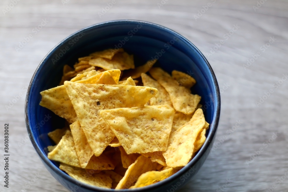 Bowl of tortilla chips on a table. Selective focus. Bowl of tortilla chips on a table. Selective focus.