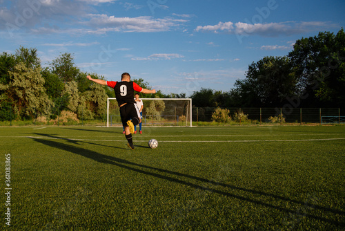 Fotografija Soccer player kicks the ball.Soccer player takes the free-kick.