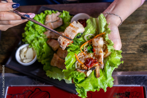 Hot asian meat dish with lettuce leaf
