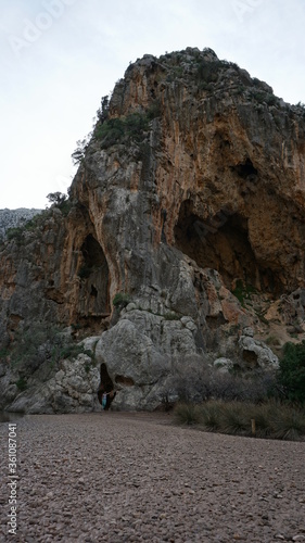 a woman in a cave in the Torrent de Pareis, Serra de Tramuntana, Mallorca, Spain, in the month of January