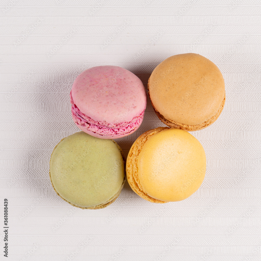 Four macaroons on white vinyl background Four macaroons on white vinyl background