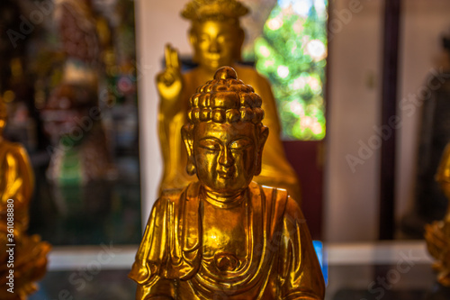 Golden buddha statues in buddhist temple. World traditional religions. Ancient traditional architectural monuments in Himalaya region. Buddhism symbols. Prayer and meditation in buddhist monastery. © ST-art