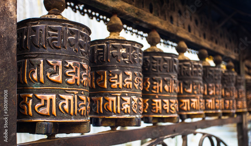 Prayer wheels in Nepal buddhist temple. World traditional religions. Ancient traditional architectural monuments in Himalaya region. Buddhism symbols. Prayer and meditation in buddhist monastery.