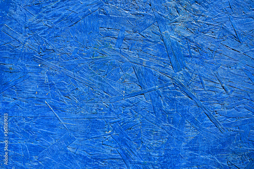 Oriented particle board in blue, OSB. A multilayer sheet consisting of wood chips glued with resin. The OSB texture is blue. Construction material. photo