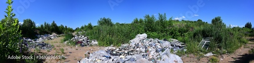 Panoramic 360 photo of garbage in the field against the blue sky in summer sunny weather