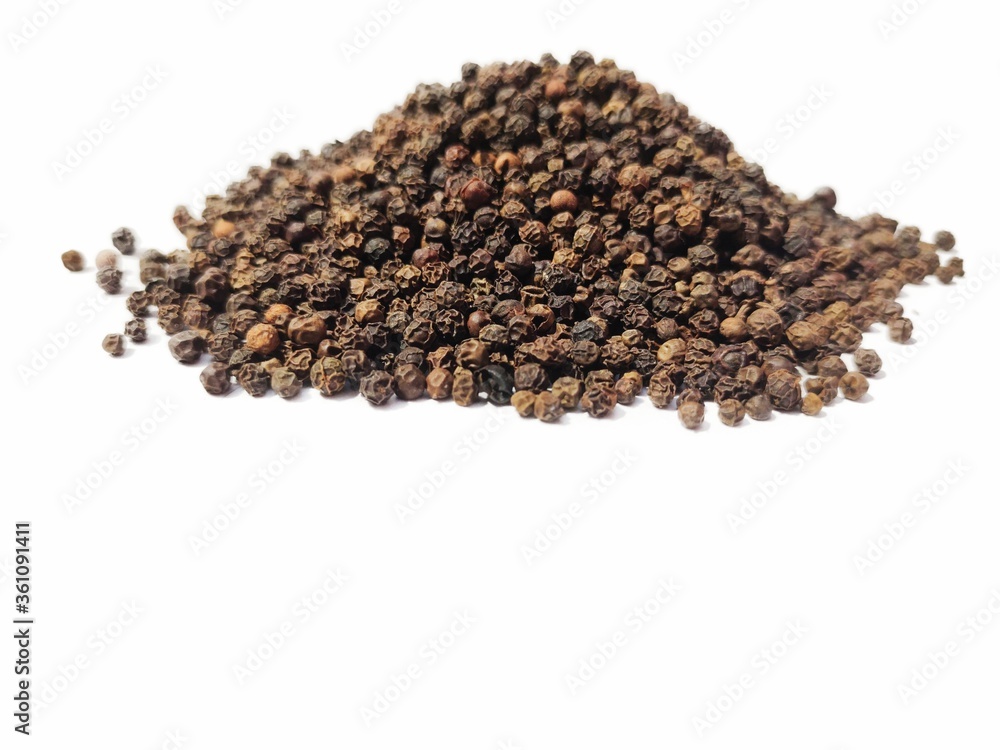 Dry Black peppercorns heap on white background sideview . Dry Black peppercorns heap on white background sideview .