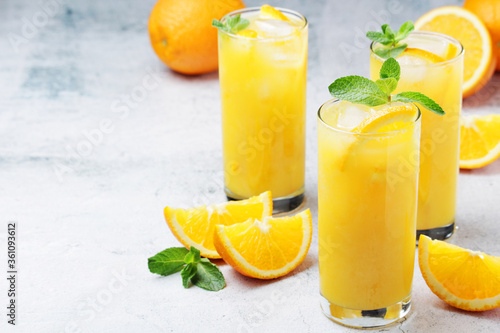 Glasses full of orange juice with ice