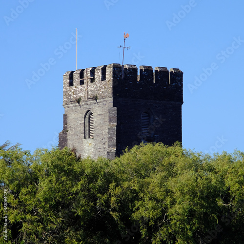 View of old church tower rising above the trees