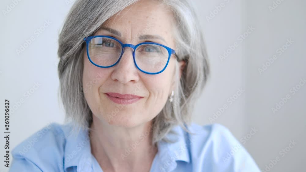 Senior lady looking at camera and smiling, success and happiness, femininity Senior lady looking at camera and smiling, success and happiness, femininity