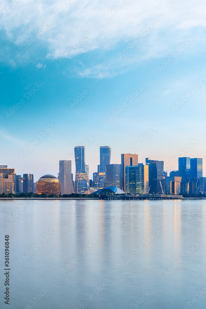 Hangzhou city skyline and architectural reflections at sunrise,China.