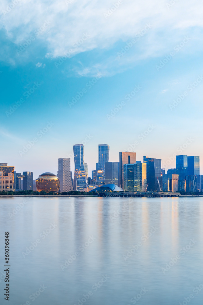 Hangzhou city skyline and architectural reflections at sunrise,China. Hangzhou city skyline and architectural reflections at sunrise,China.