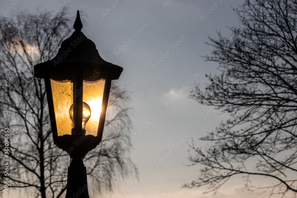 a lantern glowing against a blue sky a lantern glowing against a blue sky