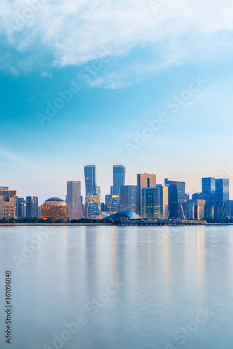 Hangzhou city skyline and architectural reflections at sunrise,China.