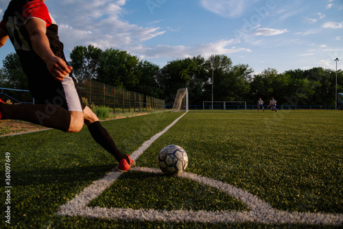 Soccer player kicks the ball.Soccer player takes a corner kick
