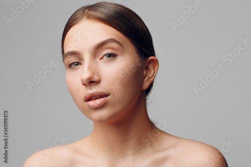 Portrait of young beautiful positive woman with nude make up.