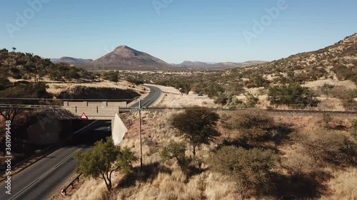 4K aerial drone video of African savanna hills, railway bridge over B1 highway south of Windhoek in central highland Khomas Hochland of Namibia, southern Africa photo