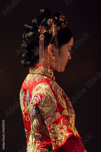 Asian girl wearing red republican dress in dark background