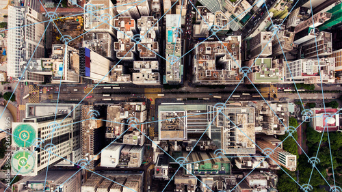 Top view aerial photo of a Hong Kong business center with development infrastructure and tall skyscrapers. Wireless cityscape map with infographics icons, internet and networking connection concept © BullRun