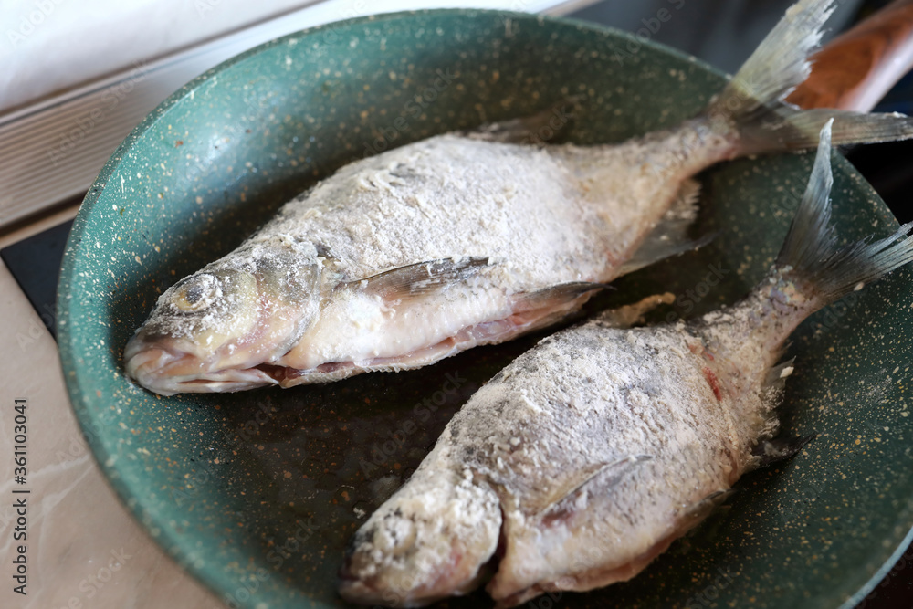 Frying fish in pan