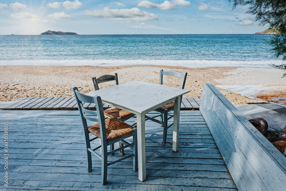 Lesbos island, Greece - A beautiful seat in the Aegean Sea on the island of Lesvos, facing the sea. Romantic dinner in the restaurant on holidays. Greece tavern.