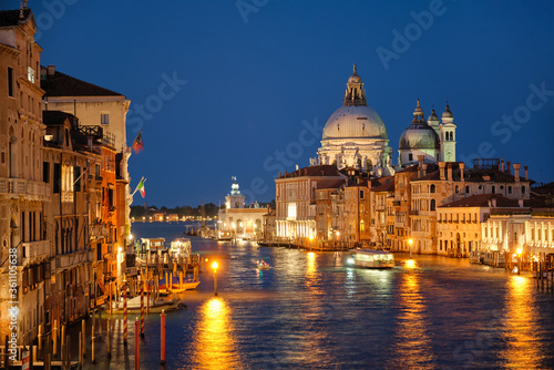 View of Venice Grand Canal with boats and Santa Maria della Salute church in the evening from Ponte dell'Accademia bridge. Venice, Italy © Dmitry Rukhlenko