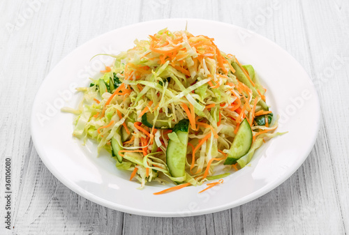 Fresh vegetable salad with cabbage, carrot, green onion and cucumber