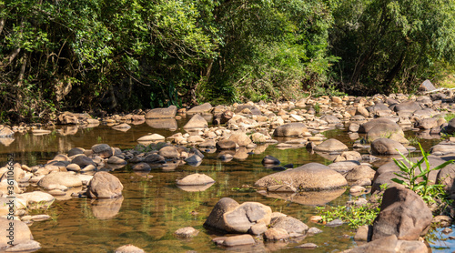 Small stream of fresh water and rolled stones in the interior of Brazil