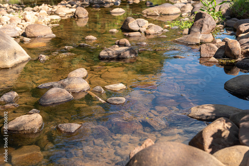 Small stream of fresh water and rolled stones in the interior of Brazil