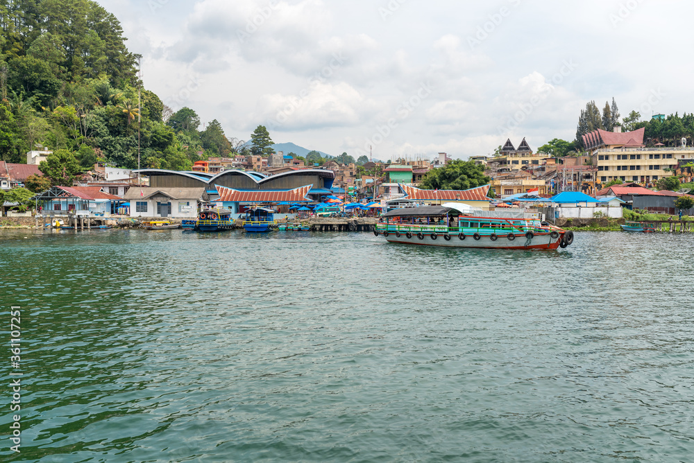 The small town Parapat with its ferry port Tiger Raja at the lakeshore of the Lake Toba, the largest volcanic lake in the world. The town is connecting point and ferry harbor to the island of Samosir