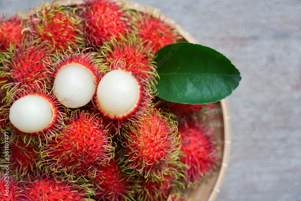 Red rambutan sweet and freshness fruit from Thailand  garden in the basket background