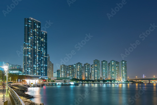 Seaside promenade and harbor of Hong Kong city at night © leeyiutung