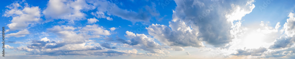 Fototapeta premium Panoramic view of blue sky with clouds and sun.