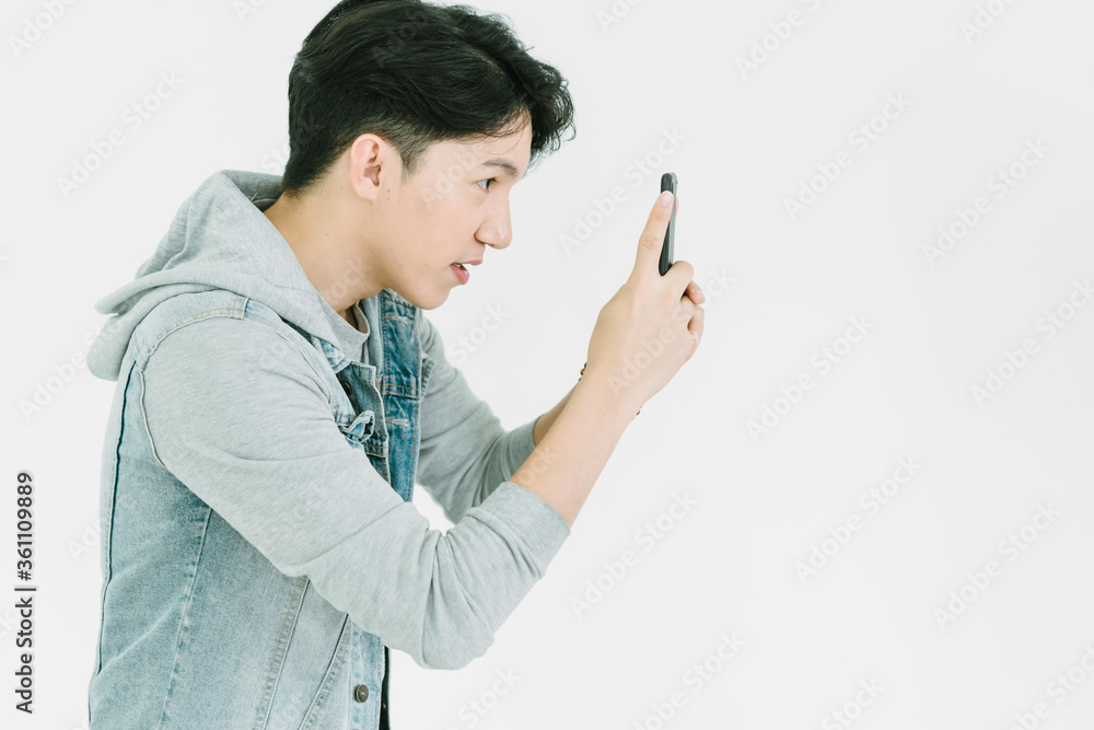 Asian Photographer shooting with Mobile Phone in studio on White background Asian Photographer shooting with Mobile Phone in studio on White background