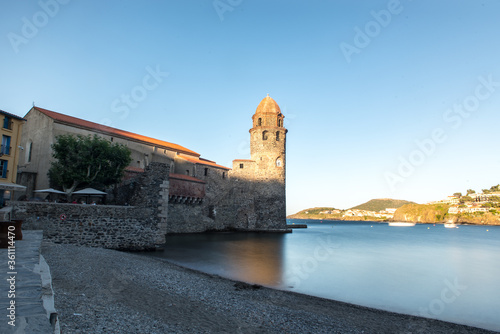 Beautiful autumn day in the tourist city of Colliure in Occitania whit on back the church of Notre dames des Anges, France. photo