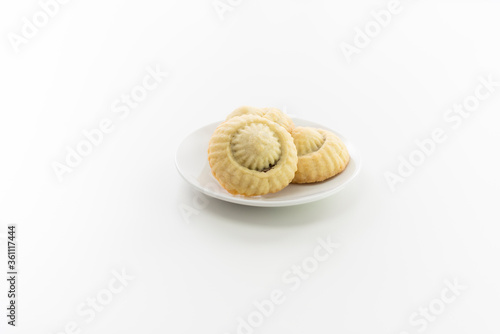 3 home made coockies on white plate, white background.