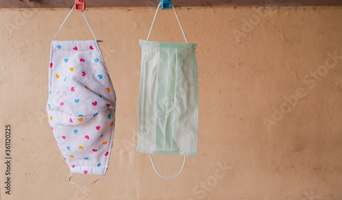A cloth face mask hung on a drying rack in the morning creates a way to prevent pollution from dust and viral outbreaks, such as covid-19 and other viruses.