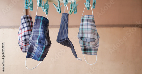 A cloth face mask hung on a drying rack in the morning creates a way to prevent pollution from dust and viral outbreaks, such as covid-19 and other viruses.