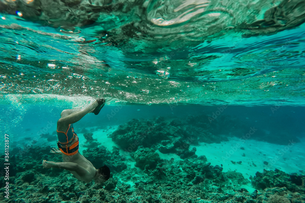 man snorkeling in the sea. underwater