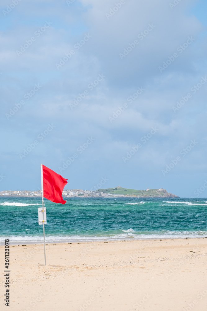 Flags on the beach for swimming surfing cornwall uk 