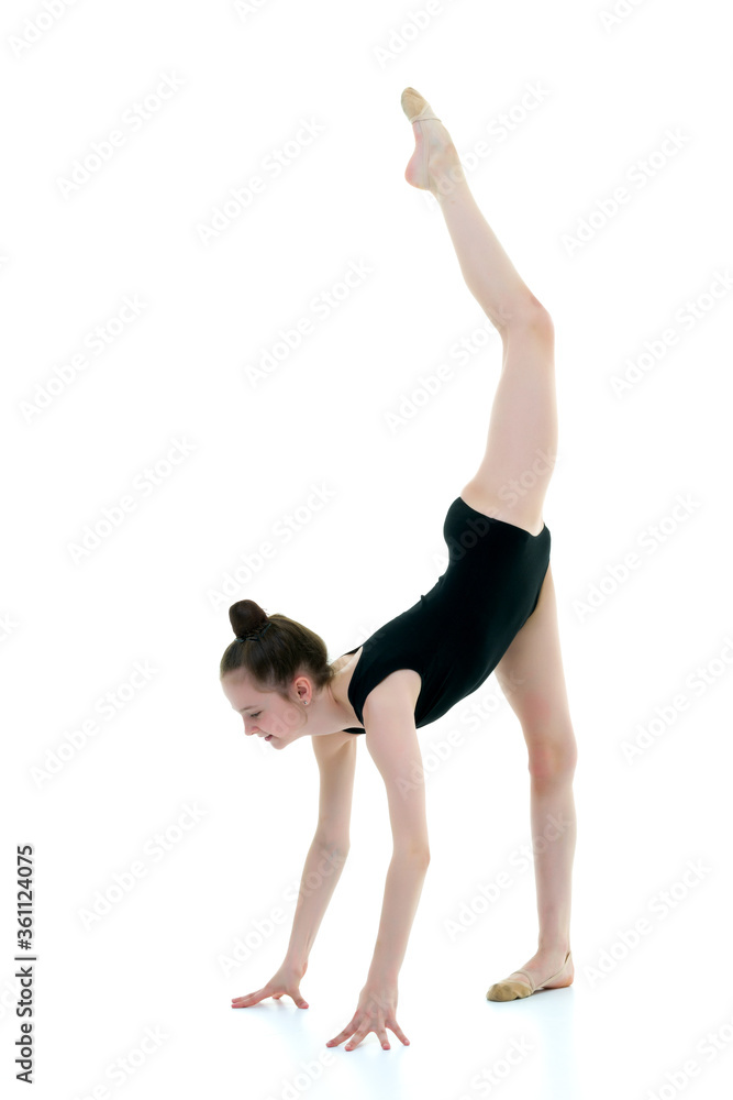 The gymnast perform an acrobatic element on the floor. The gymnast perform an acrobatic element on the floor.