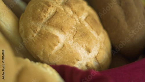 Close up fucosed and unfucosed view of white and wheat bread on basket red cloth. Good and bad type of bread, source of calorie and carbs. Food, nutrition and health concept. photo