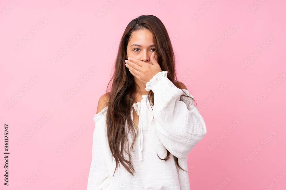 Young Brazilian girl over isolated pink background covering mouth with hands Young Brazilian girl over isolated pink background covering mouth with hands