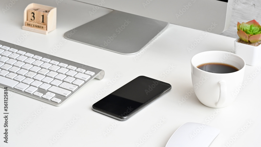 Modern white office desk table with laptop computer, blank screen and coffee cup. Modern white office desk table with laptop computer, blank screen and coffee cup.