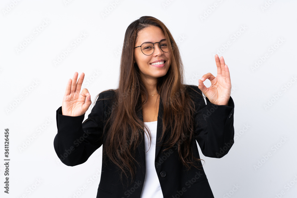Young Brazilian girl with blazer over isolated white background showing an ok sign with fingers Young Brazilian girl with blazer over isolated white background showing an ok sign with fingers