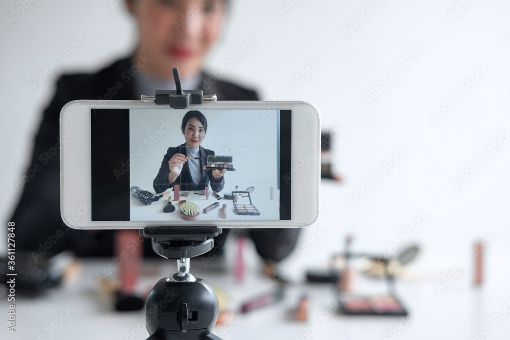 Woman blogger is showing present tutorial beauty cosmetic product and broadcast live Woman blogger is showing present tutorial beauty cosmetic product and broadcast live