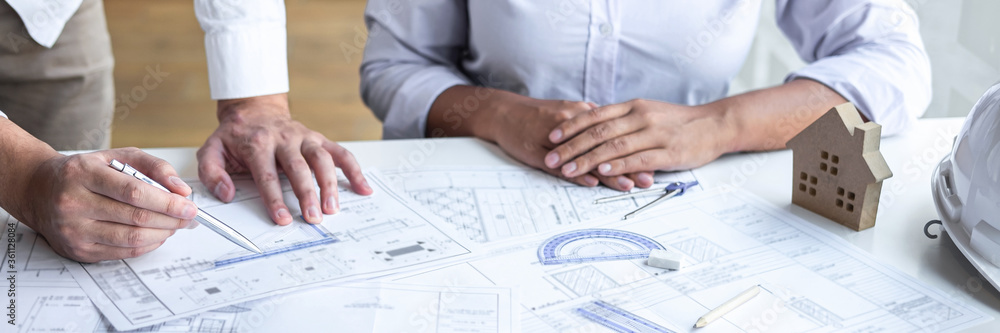engineering discuss a blueprint while checking information on project engineering discuss a blueprint while checking information on project