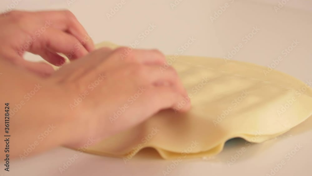preparing ricotta cheese ravioli pasta in a plastic ice cube trays with a tart dough