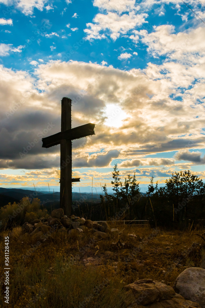 Sihouette of Cross Overlooking The Sangre de Cristo Mountains, Truchas, New Mexico, USA