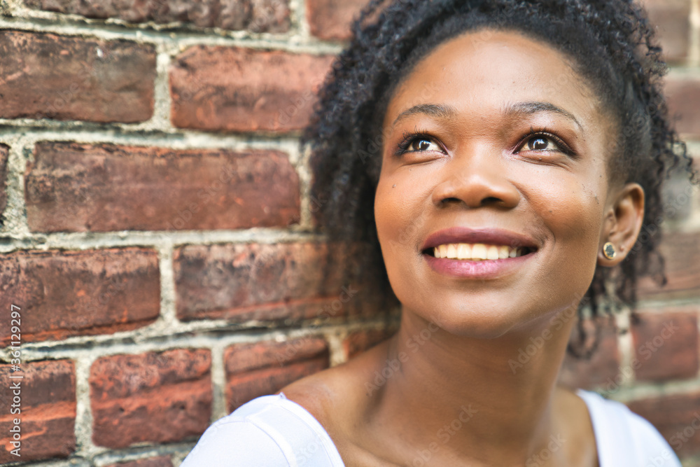 Colombian fashion woman outside close to a brick wall