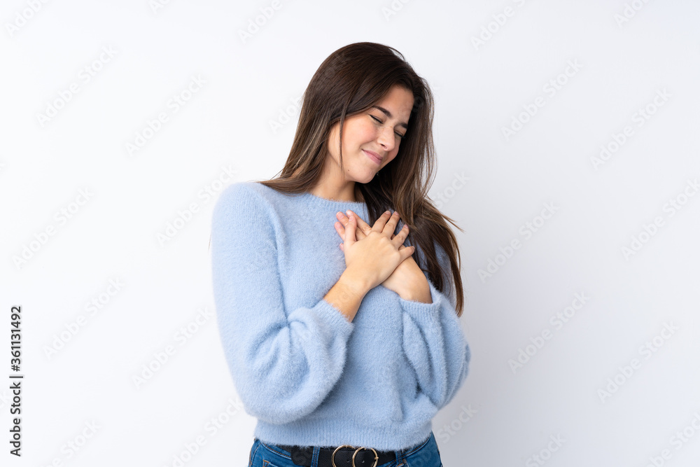 Teenager girl over isolated white background having a pain in the heart Teenager girl over isolated white background having a pain in the heart